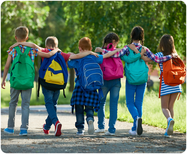 Children walking away from the camera arm in arm