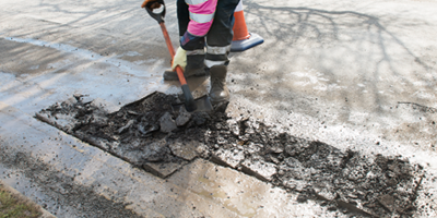 Workmen excavating a pothole