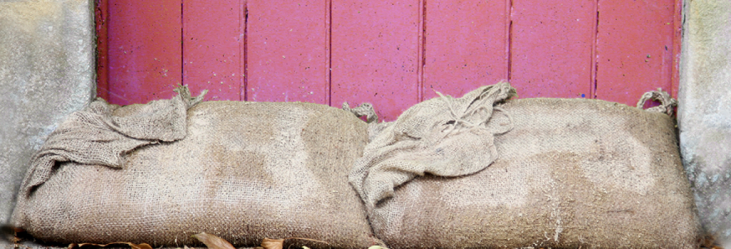 Sandbags by a pink door